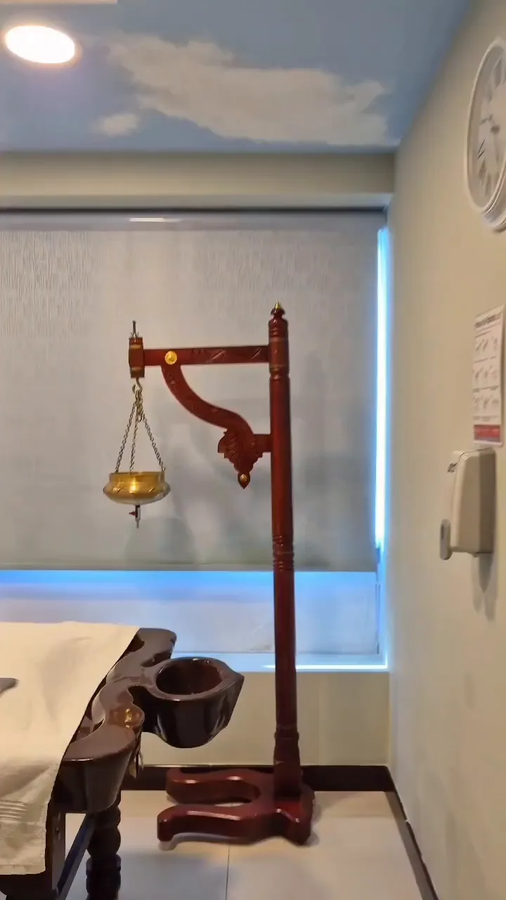 Ayurvedic treatment room with a Shirodhara stand